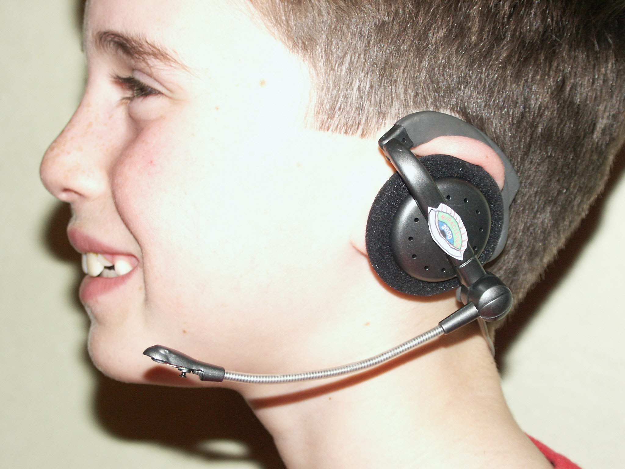 Photo of earpiece and microphone on user's head.