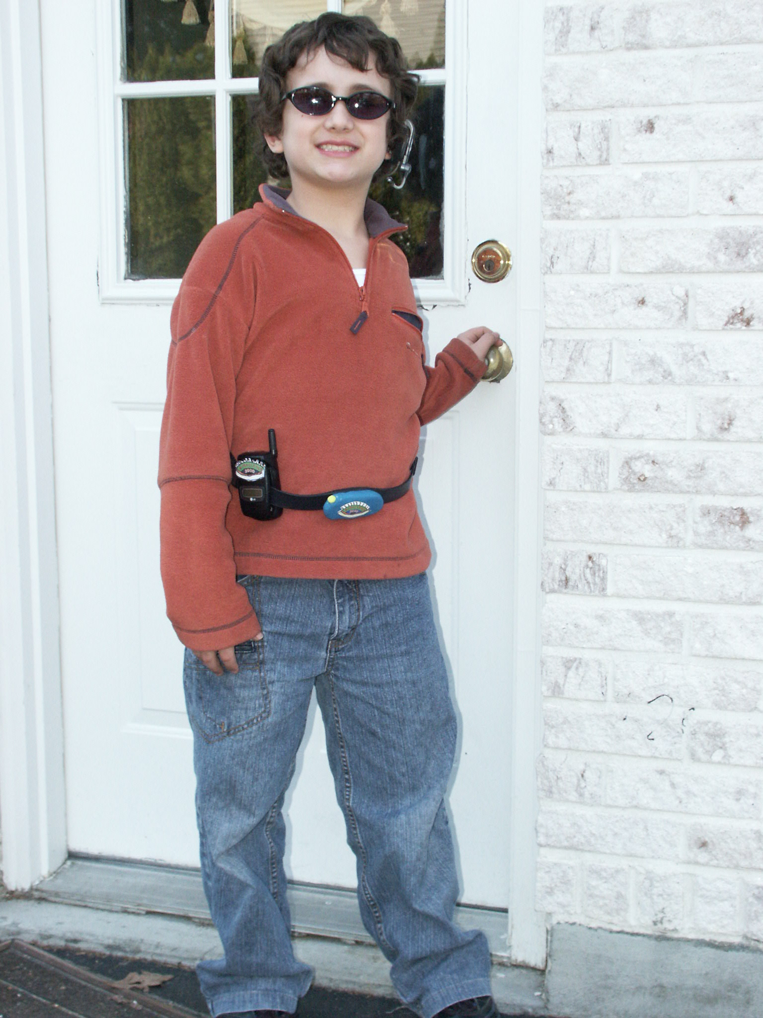 Photo of boy with MiraclEyes' equipment on walking out of his house.